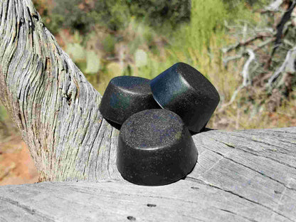 Black Sun Orgonite® Tower Busters on wood, powerful orgone generator for EMF protection and home energy.