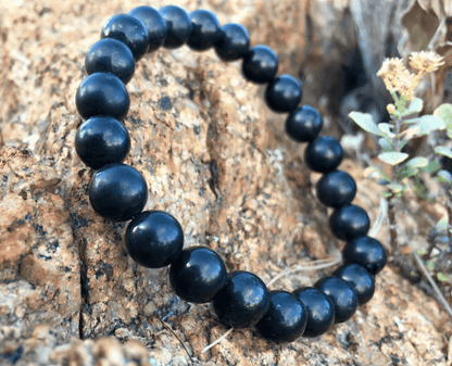 Shungite Jewelry is handmade in Karelia, Russia. This beaded bracelet has several polished 8mm round beads strung on a strong standard size elastic band