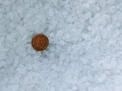 Clear Quartz Crushed Chips – Natural Brazilian Healing Crystal shown with a penny for size reference. Ideal for crafts, jewelry, and orgonite projects.
