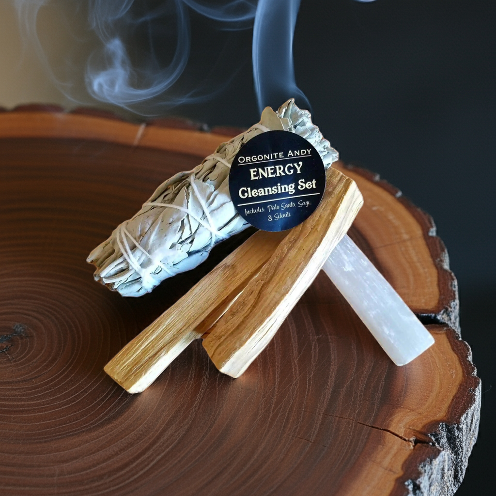 Energy cleansing smudge kit arranged on wooden surface with burning sage and crystals