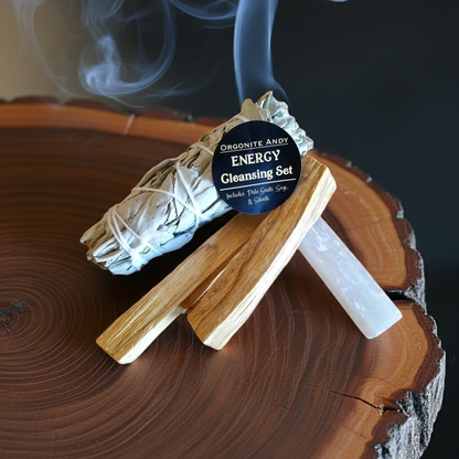 Energy cleansing smudge kit arranged on wooden surface with burning sage and crystals